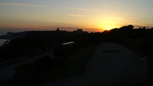 Image of the setting sun with Dover Castle in silhouette